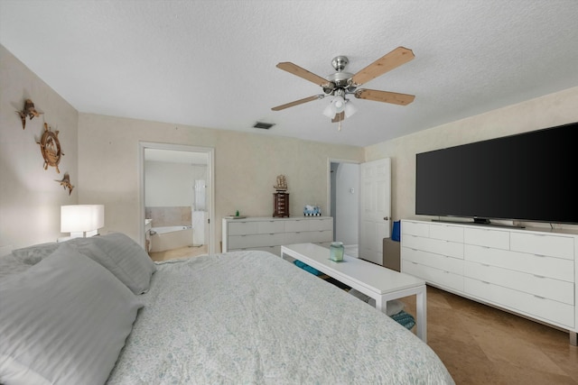 bedroom featuring a textured ceiling, ceiling fan, and ensuite bath