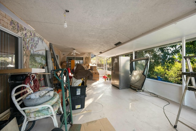 sunroom / solarium featuring ceiling fan