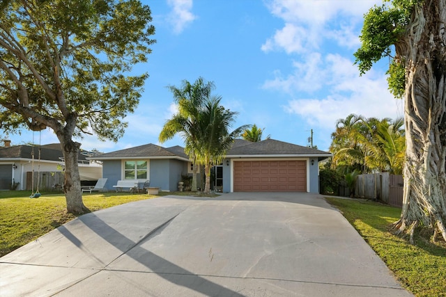 single story home featuring a garage and a front yard