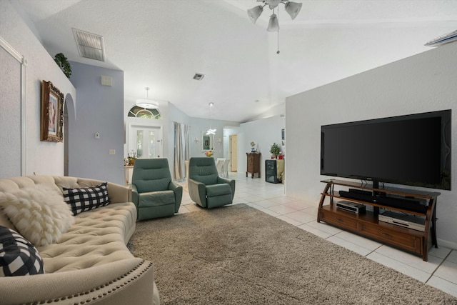 tiled living room featuring lofted ceiling and ceiling fan