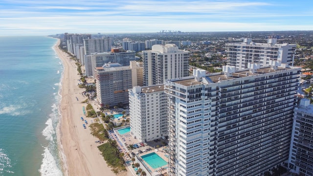 birds eye view of property featuring a beach view and a water view