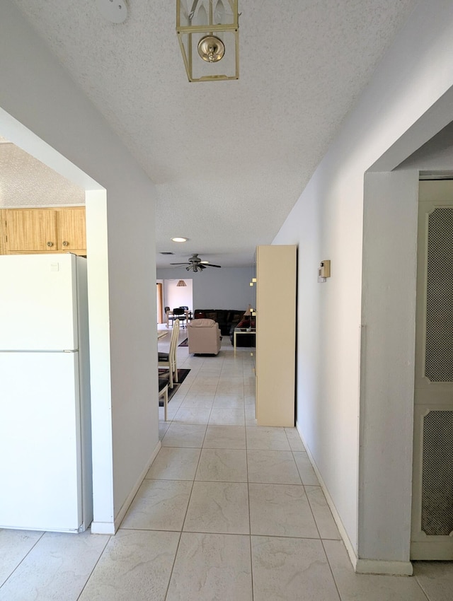 hallway with a textured ceiling