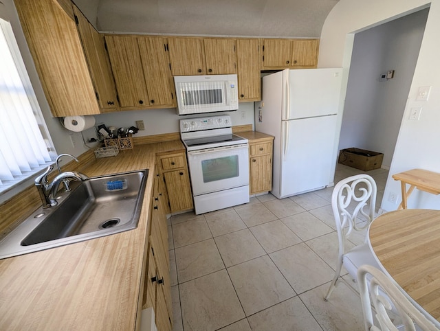 kitchen with light tile patterned flooring, white appliances, and sink