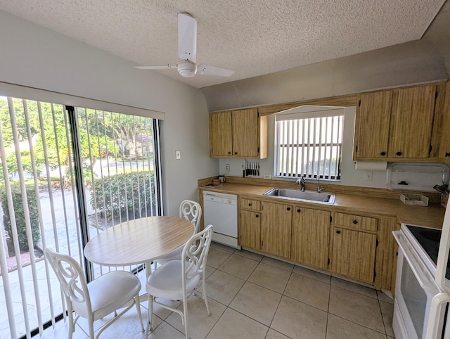 kitchen featuring white appliances, sink, ceiling fan, a textured ceiling, and light tile patterned flooring