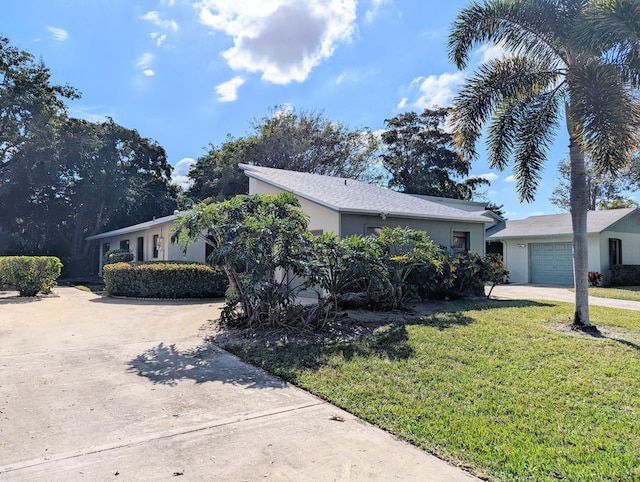 single story home featuring a front yard and a garage