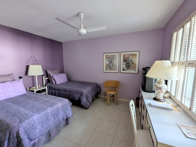 tiled bedroom with multiple windows and ceiling fan