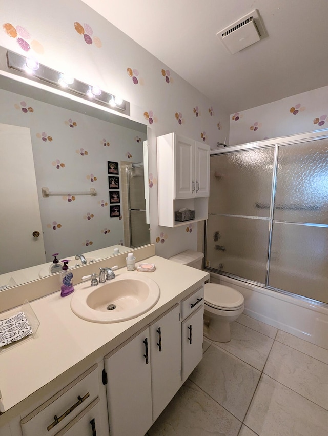 full bathroom with combined bath / shower with glass door, vanity, and toilet