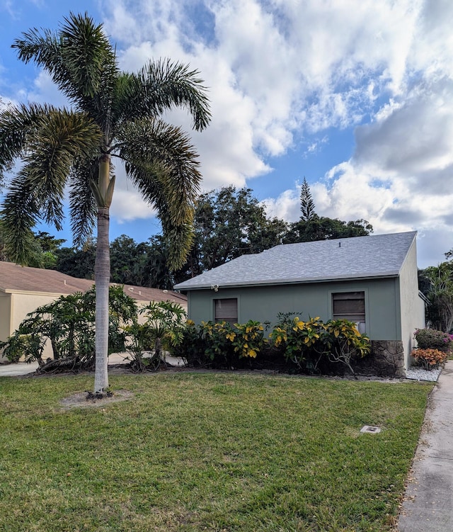 view of side of property with a lawn