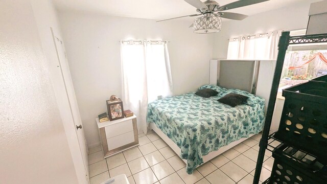 bedroom featuring light tile patterned floors and ceiling fan