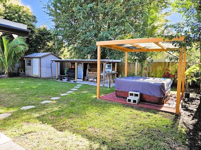 view of yard with a hot tub, a patio, and a storage unit