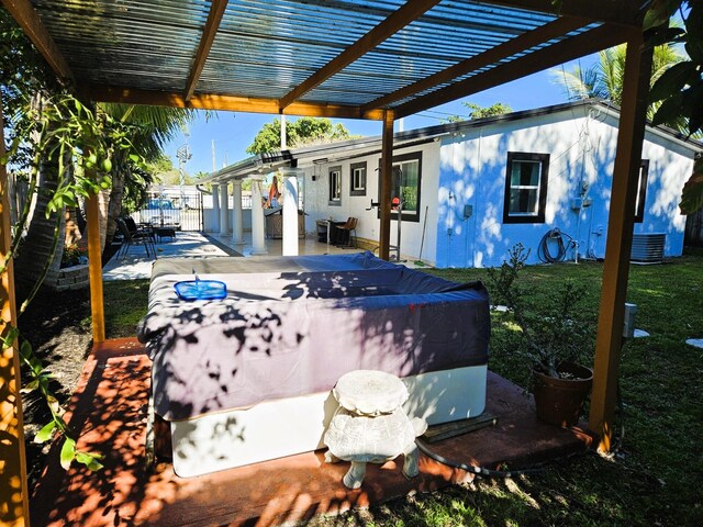 view of patio with central AC unit and a jacuzzi