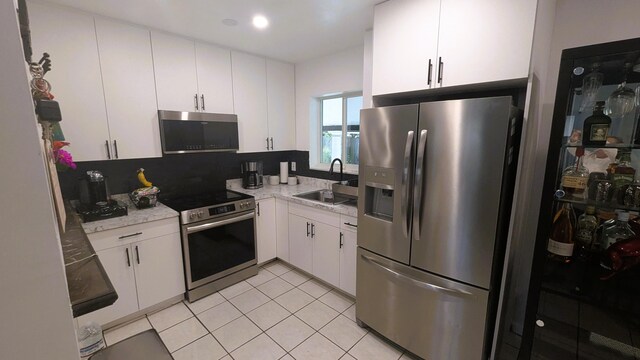 kitchen featuring white cabinetry, appliances with stainless steel finishes, and sink