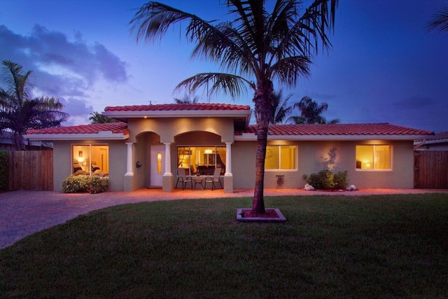 mediterranean / spanish house featuring a yard and a patio