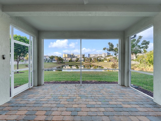 unfurnished sunroom with a water view