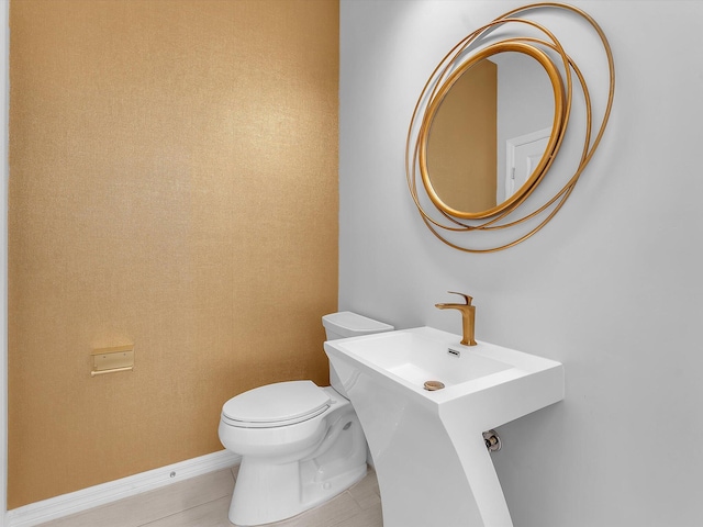 bathroom with toilet and tile patterned flooring