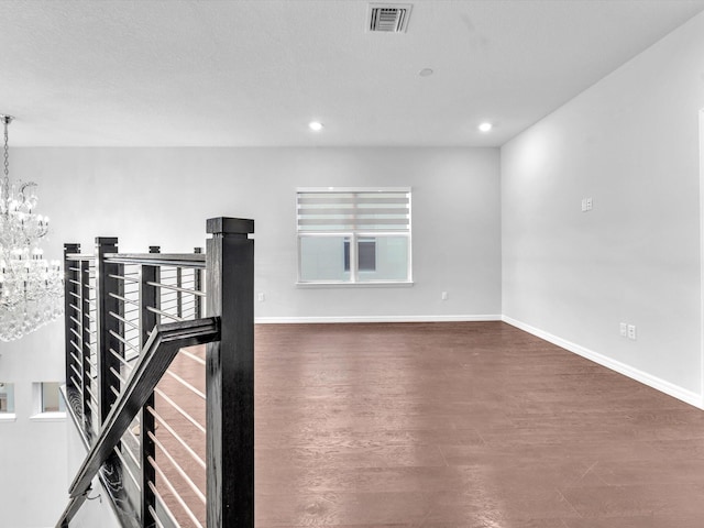 interior space featuring dark wood-type flooring and a notable chandelier