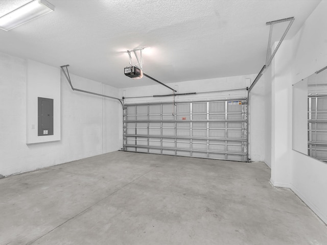 garage with a garage door opener and electric panel