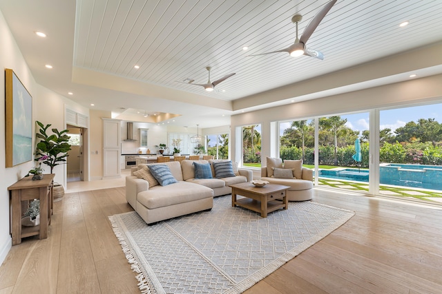 living room featuring wooden ceiling, ceiling fan, and light hardwood / wood-style flooring