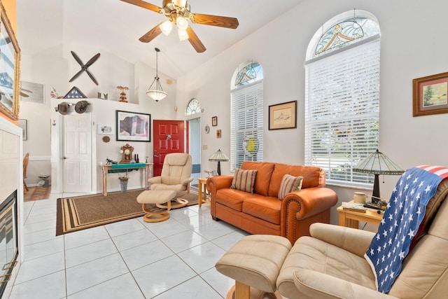 tiled living room featuring ceiling fan and vaulted ceiling