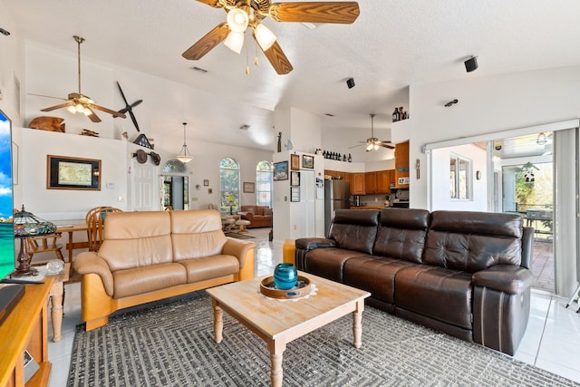 tiled living room with a textured ceiling and high vaulted ceiling