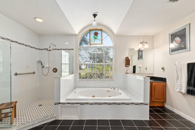 bathroom with tile patterned flooring, vanity, lofted ceiling, and shower with separate bathtub