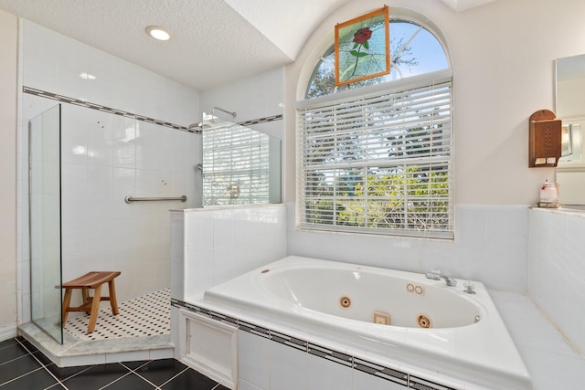 bathroom featuring tile patterned floors, a textured ceiling, and plus walk in shower