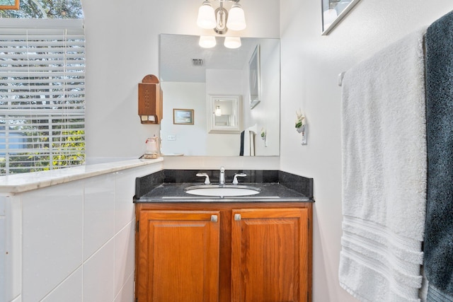 bathroom featuring vanity and an inviting chandelier