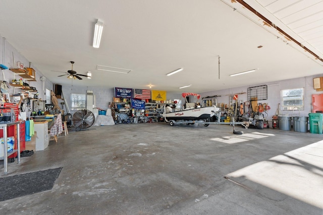 garage with a workshop area and ceiling fan