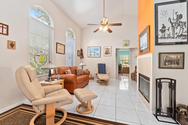 living room featuring light tile patterned floors, vaulted ceiling, and ceiling fan