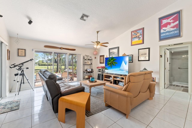 12354 Golden Eagle St, Port Saint Lucie, FL 34987 - living area featuring light tile patterned floors, lofted ceiling, ceiling fan, and a textured ceiling