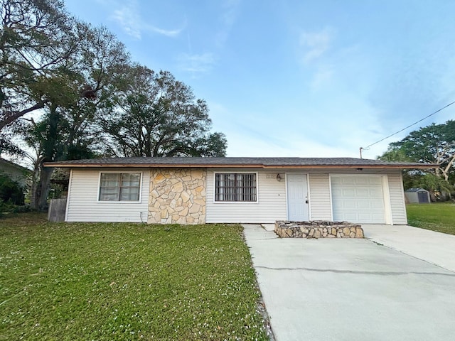 ranch-style house with a front yard and a garage