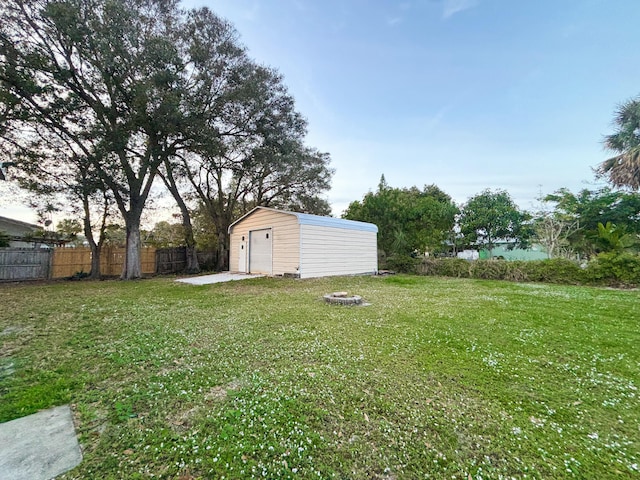 view of yard with a fire pit and a storage shed