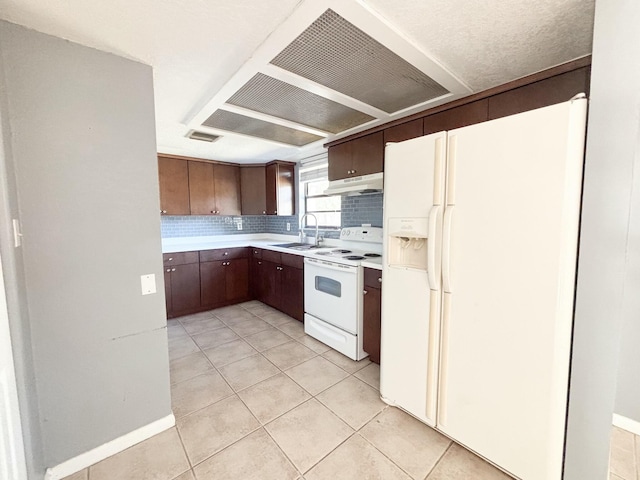 kitchen featuring white appliances, sink, light tile patterned floors, tasteful backsplash, and dark brown cabinets