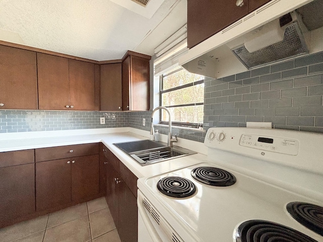 kitchen with backsplash, white range with electric stovetop, light tile patterned floors, and sink