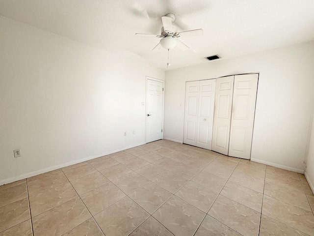 unfurnished bedroom with ceiling fan and light tile patterned floors