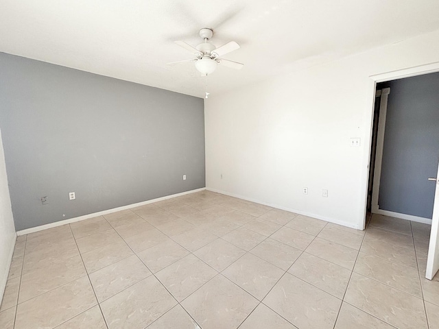 unfurnished room with ceiling fan and light tile patterned floors