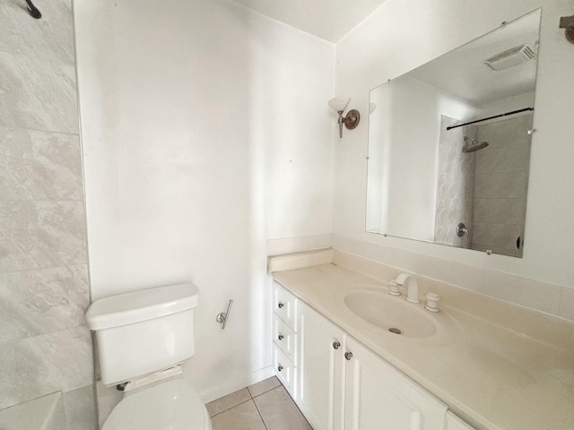 bathroom featuring tile patterned floors, vanity, and toilet