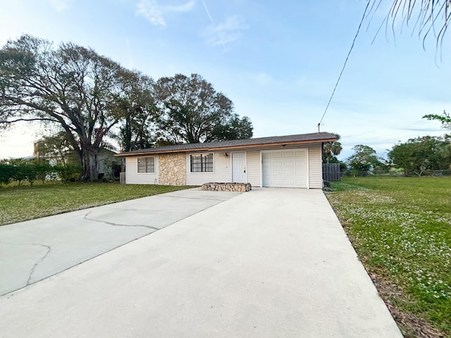 ranch-style house featuring a front lawn and a garage