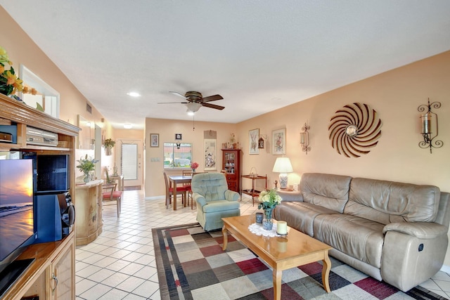 tiled living room with ceiling fan