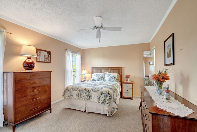 bedroom with a textured ceiling, ceiling fan, ornamental molding, and light colored carpet