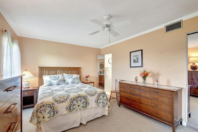 carpeted bedroom featuring ornamental molding, a textured ceiling, and ceiling fan