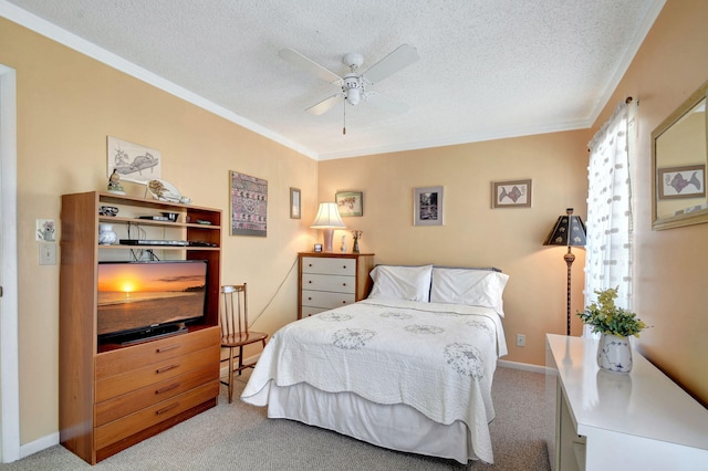 bedroom with ceiling fan, crown molding, light carpet, and a textured ceiling