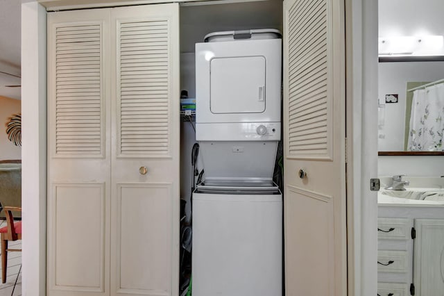 laundry room featuring sink and stacked washing maching and dryer