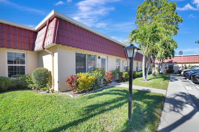 view of side of home featuring a lawn