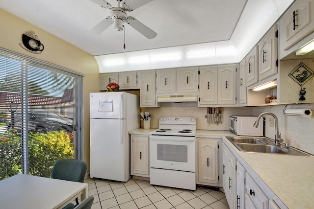 kitchen with sink, white appliances, light tile patterned flooring, and ceiling fan