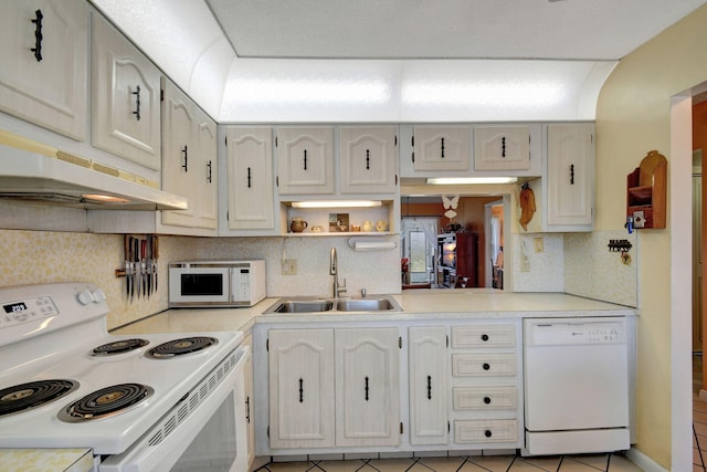 kitchen with white appliances, tasteful backsplash, sink, and light tile patterned floors