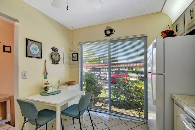 dining space with light tile patterned flooring and ceiling fan