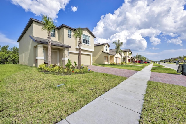 view of front of property featuring a garage and a front yard