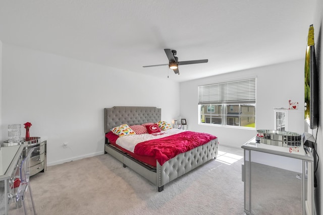 bedroom with ceiling fan and light carpet