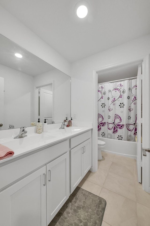 full bathroom featuring tile patterned floors, shower / bath combo with shower curtain, vanity, and toilet